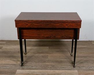        292	Mid Century Modern Tambour Dining Table and Server	"Mid Century Modern tambour dining table and server. Mid 20th Century. Laminate wood paneling, metal legs on casters. Server converts into a long dining table from a pullout mechanism. Minimal scuffing and wear to surface, back panel of piece previously repaired.

Closed: 30 1/2"" H x 35 1/2"" L x 17 1/2"" D
With table open: 30 1/2"" H x 35 1/2"" L x 72 1/2"" D"