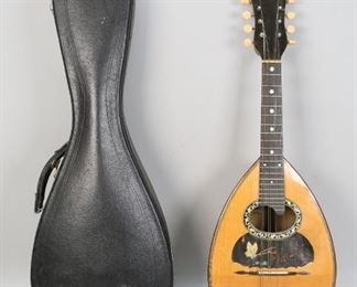        302	A. Galiano Roundback Mandolin	"A. Galiano roundback mandolin. Italian, Early 20th Century. Roundback body, carved neck, mother of pearl inlay on rosette. Tag on inside through soundhole states "" A. GALIANO R.C./  FABRICCANTE DI MANDOLINI / E CHITTARI/ GARENTITE"". Scratches and wear to body and around neck. Exterior wear and scuffing to fitted case.

26"" H x 9"" L x 7 1/2"" W"