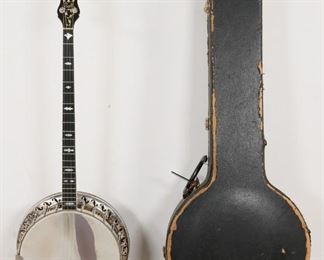        304	Bacon and Day Silver Bell Plectrum Banjo	"Bacon and Day Silver Bell plectrum banjo, with fitted case and shoulder strap. American, Early 20th Century. Made by the Bacon Banjo Co. Inc., Groton, Conn. USA. Serial number located on neck extension inside banjo states ""#17800 B & D SILVER BELL. Significant wear to drum head and around resonator, crazing on headstock, loss to veneer behind headstock. Wear throughout fitted case and loss to velvet lining. 

40"" H x 16"" L x 6"" W"