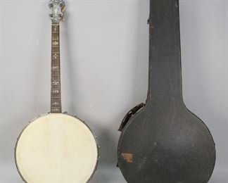        305	Rettberg and Lange Orpheum No. 1 Tenor Banjo	"Rettberg and Lange Orpheum No. 1 tenor banjo. American, Early 20th Century. Four string tenor banjo with carved neck and mother-of-pearl inlay. Rettberg and Lange label on inside of resonator, patent number 724833. Remnants of a serial number on dowel stick states '102 DO"". Small puncture to bottom of drum head, strings are missing. Wear to drum head, wear to headstock and throughout resonator.

33"" H x 14"" L x 4 1/2"" W"