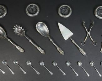        311	4 Sterling Rimmed Coasters, Silverplate Tableware	"4 sterling rimmed coasters. 4 Godinger silverplate pieces in the pattern Baroque: 1 cake server, 2 salad serving spoons, 1 pasta server. Marked on the side of the handle. 12 Italian silverplate demitasse spoons. Marked on handle. Raimond Italy silverplate figural tongs. Marked center. Metal parrot form nutcracker.
Cake server: 11 1/2"" L. 
"