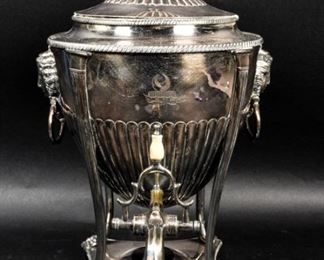        313	English Neoclassical Silverplate Coffee Urn	"English Neoclassical silverplate coffee urn. English, Late 19th/Early 20th Century. Silverplate, Egyptian Revival style moon relief motif above spout, and faces of Hathor with handles. Wear and slight abrasions throughout.

17 1/2"" H x 10"" L x 12"" W

"