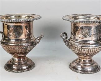        316	Pair of English Silverplate Wine Coolers	Pair of English silverplate wine coolers. Urn form, twin handled with rampant lion marking to each. 10 1/4" H x 9" top diameter. Scuffing throughout.