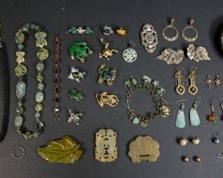        321	Grouping of Costume & Jade Jewelry	"Necklaces, pendants, bracelet, earrings and brooches.
Designers include Amy Kahn Russell, Carolee, Monet, Tomassini, Trifari, Kirk's Folley, and Jan Michaels. Chinese jade buckle and pendant.
Frog necklace: 9"" L."