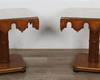        348	Pair of Hollywood Regency Style Side Tables	"Pair of Hollywood Regency side tables. American, 20th Century. Glass top covers,  checkered veneered top, carved apron with hanging brass finials, colonnade pedestal form, black bun feet. Some wear to glass and pedestal bases. 

"