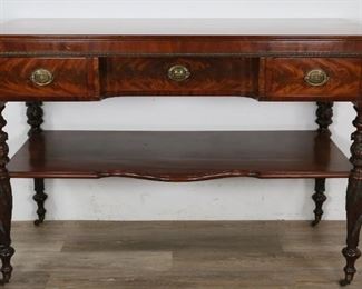        360	Regency Style Sideboard	"Regency style sideboard. English, 20th Century. Mahogany, three drawers, brass Hepplewhite medallion pulls, dovetailing, ornately carved acanthus legs on casters, lower tier. Scratches and wear to top and lower tier.

36"" H x 53"" L x 24 1/2"" D"