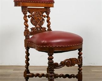        363	Continental Carved Side Gaming Chair	"Continental carved side gaming chair. 18th/19th Centuries. Contemporary leather headrest and seat with brass tacks, carved barley twist legs and stretcher, carved seat back with crossed pipe motif. Headrest opens up to reveal a storage compartment. Wear to feet and leather seat.

32"" H x 17"" L x 16"" W"