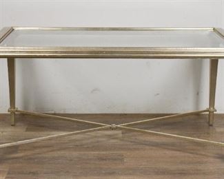        362	Louis XVI Style Silver Tone Cocktail Table	"Louis XVI style silver tone cocktail table. Colonnade feet, silver tone paint, ""X"" stretcher, beveled glass top. Some wear to border around glass top.

19"" H x 42"" L x 26"" W"