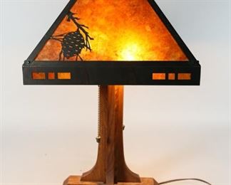        371	Mica Lamp Co. Table Lamp	"Mica table lamp, four panel mica shade with copper frame and branch overlays, on oak lamp base. Base and shade both marked Mica Lamp Co. California.

23"" H x 10 1/4"" diameter."