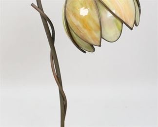        376	Handel Style Art Nouveau Tulip Form Lamp	"Handel Style Art Noveau tulip form lamp. American, Early 20th Century. Glass shade in tulip form on metal leaf form base. "" BCL DC 2"" stamped on underside of base. Wear to base, original wire has been stripped. Shade is loose from fitting.

16"" H x 7"" diameter of base"