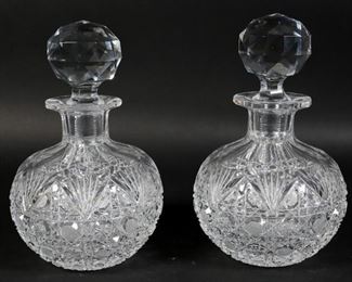        382	Pair of Cut Glass Decanters	Pair of cut glass decanters. Chips to both stoppers. Scuffing to the underside of each. Fleabites. Chips to collar. Bubbles to the interior of stopper. Base to top of stopper: 8 1/4" H.