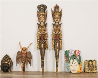        386	6 Balinese Wood Masks and Sculptures	"6 Balinese wood masks and statues. 3 masks. 3 statues: Pair of polychrome wall hanging deity statues and Goddess Dewi Sri mobile. Dewi Sri mobile has arms and wings loose. Crack to 1 mask. Wear to paint, top of female deity sculpture. Flower mask inscribed on verso: "" Mask Design. IW. SUBA"".
1 Deity: 47 1/2"" x 7 1/2"".
Largest mask: 15 1/2"" x 11""."