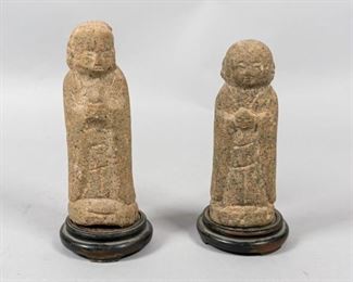        389	2 Korean Stone Arhat Statues	"Korean stone Arhat statues in the form of Monks. 
Late Goryeo or early Joseon Dynasty (1392-1910).
5 1/4"" H and 5 3/4"" H.
with stands: 5 5/8"" H and 6 1/2"" H. 
Chip to the head of the tallest statue."