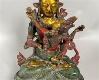        392	Tibetan Yab Yum Polychrome Bronze Deity	"Circa 17th to 18th Century Tibetan bronze statue with two deities together in an interpretation of wisdom and compassion. Bronze gilt with polychrome paint. They hold a bell and vajra in their hands depicting duality. 
""The male figure represents compassion and skillful means, while the female partner represents insight. In yab-yum the female is seated on the male’s lap.""
Cited from:
Simmer-Brown, J. (2002). Dakini's Warm Breath: The Feminine Principle in Tibetan Buddhism. Shambhala. p. 159. 
8 1/2"" L x 6"" W x 12 1/2"" H. 
Wear to paint, dirt accumulation in the relief."