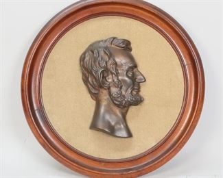        419	Abraham Lincoln Metal Cameo Plaque	Patinated metal cameo of President Abraham Lincoln. Velvet background in round mahogany frame. 14 1/2" Diameter.