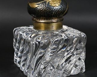        423	Crystal Inkwell with Hammered Metal Lid	"Crystal inkwell with hammered metal lid, gold tone floral applique. 4"" L x 4"" W x 5 1/4""H.
Scuffing to the underside. 
"