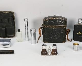        443	Toiletry Case, 2 Whiskey Flasks & Opera Glasses	Men's toiletry leather case: 1 comb, 1 oval brush, 1 metal case and 2 containers. 2 glass whiskey flasks with leather covers in embossed leather case with strap. Chevalier Opticien Paris opera glasses with leather case, marked on the rim. Metal and hide leather opera glasses. Toiletry case: 7 1/4" L x 7 1/4" W. Whiskey flask case: 7 1/2" H. Wear to leather surfaces. Scuffing to the metal on opera glasses.