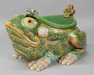        447	Bordallo Pinheiro Ceramic Frog Spittoon	Raphael Bordallo Pinheiro (Portuguese, 1846-1905) ceramic frog spittoon. Marked on the underside, black stamp. 2 chips to the underside, crazing to the lid and face of frog. 13 1/2" L x 9"W x 7 1/4"H.