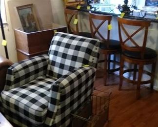 checkered arm chair, antique dry sink bar stools and great art work