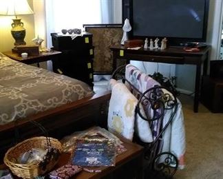 Flat screen TV, writing desk, black velvet storage boxes, antique fireplace screen, great art work