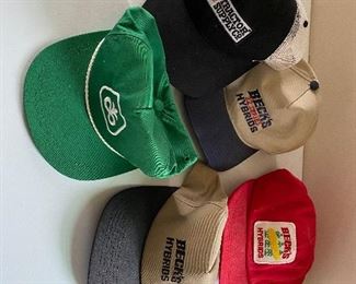 Caps with various seed company logos
