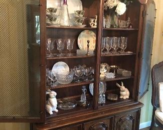 Mid century China hutch filled with glassware and China special occasion dishes and bunnies