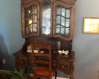 Curio bookcase desk, Ladder back chair, wicker basket with silk plant