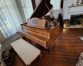 A classic Baldwin baby grand piano, tuned on a regular basis.  