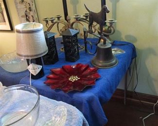 handmade iron candle holder in background. Dog bell mounts to a wall