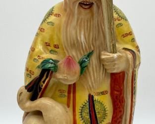 Vintage Asian figurine man with bird and staff