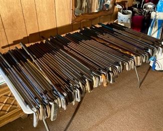 Hundreds of golf clubs and several golf bags