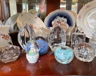 Glass pieces, paper weights, and decorative plates.