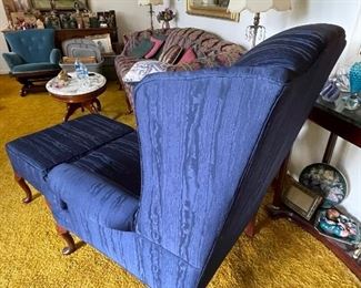 Blue wing back chair with a beautiful pattern and matching footstool.