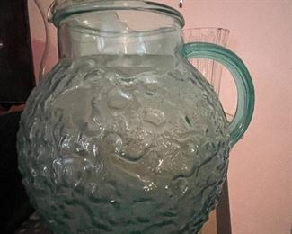 Teal glass pitcher with bubble detail.