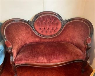 Rust colored Victorian Era sofa.