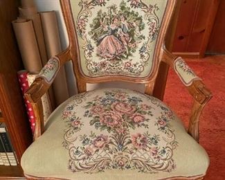 Needle point pattern decorative chair. Victorian era with beautiful wooden details on the chair.