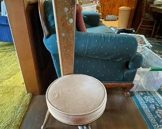 3 legged stool with interesting and decorated back.