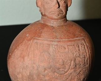 Pre-Columbian Tiawaka-Wari bottle vessel.  Due to the nature of his face, this could possibly be used for ceremonial activity. 