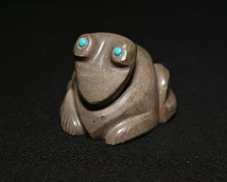 Carved Zuni stone toad with turquoise eyes.