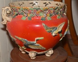 This is a very old fish bowl style footed pot, which is heavily decorated with birds and flowers.