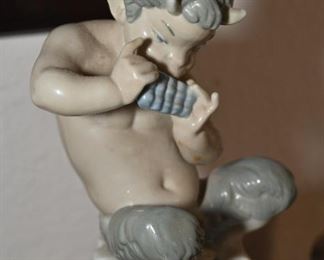 Lladro Satyr playing a pan flute-  His legs are broken but are available for repair.