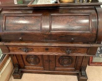 Antique English roll top desk.  Gorgeous piece put together with wooden pegs.  Very heavy but top lifts off from bottom for moving purposes.  48x24x49. $1000.00
