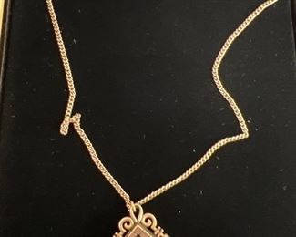 Gold diamond and revised cameo in onyx locket