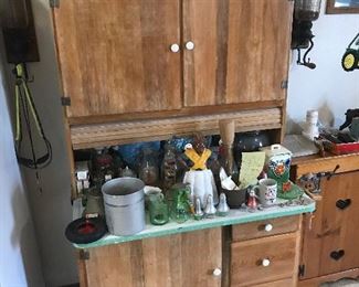 A Sellers Kitchen cabinet, Note the ethnic maid door stop & the ( 2(of the 10) coffee grinders on each side plus all the other antiques...