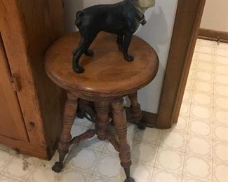piano stool and another door stop = Boston Terrier