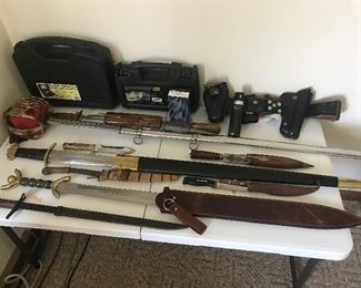A wide variety of jack knives (not pictured), knives, swords  pistol cases and an officers equipment belt.