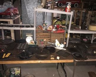 A wide variety of cast iron cookware, a dozen egg graters & crates.