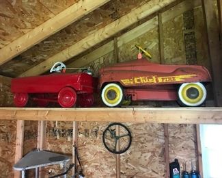 on the left - 1961 Fire Chief by Murray                                      on the right - 1955 Chief Fire w/ jet flow drive                  Both need some TLC                                                                        Note the John Deere steering wheel below