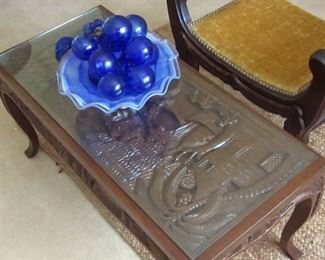 Carved top, glass protected, coffee table
