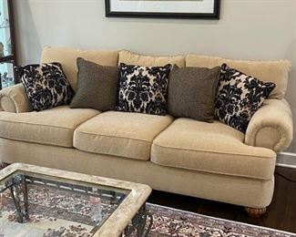 Flexsteel 3 Cushion sofa in cream/sand. Rolled arms, padded front rail, overstuffed seat and back cushions, fluted bun feet. Purchased 6 years ago, barely used. 96"w x 42"d x 40 H. Arm height 27"
